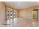 Living room with tile floors and sliding doors to patio at 20621 N Canyon Whisper Dr, Surprise, AZ 85387