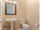 Powder room with pedestal sink and toilet at 20621 N Canyon Whisper Dr, Surprise, AZ 85387