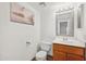 Clean bathroom with wood vanity, tile shower, and updated fixtures at 2121 S Pennington Rd # 12, Mesa, AZ 85202
