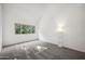 Bright bedroom with grey carpet, large window, and a floor lamp at 2121 S Pennington Rd # 12, Mesa, AZ 85202