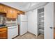 Bright kitchen features wood cabinets, white appliances, and tile floor at 2121 S Pennington Rd # 12, Mesa, AZ 85202