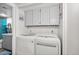 White stacked LG washer and dryer with upper cabinets at 2121 S Pennington Rd # 12, Mesa, AZ 85202