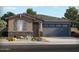 One-story home with gray garage doors and stone accents at 24344 W Graham Trl, Buckeye, AZ 85326