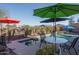 Poolside patio furniture and umbrellas at 24810 W Huntington Dr, Buckeye, AZ 85326