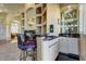 Wet bar with granite countertop and glass shelving at 25633 N Abajo Dr, Rio Verde, AZ 85263