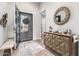 Open entryway with modern dark door and geometric console table at 26203 W Maple Dr, Buckeye, AZ 85396