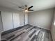 Bedroom with ceiling fan, neutral color scheme, gray wood floors and closet with sliding doors at 2629 W Ocotillo Rd # 3, Phoenix, AZ 85017
