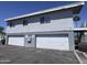 Two-story apartment complex with garage, staircase and textured exterior under a clear sky at 2629 W Ocotillo Rd # 3, Phoenix, AZ 85017