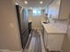 Galley kitchen featuring new stainless steel appliances, marble backsplash and gray wood floors at 2629 W Ocotillo Rd # 3, Phoenix, AZ 85017
