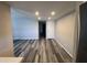 Open living room with neutral color scheme and gray wood floors flowing into the kitchen at 2629 W Ocotillo Rd # 3, Phoenix, AZ 85017