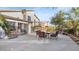 Enjoy the spacious backyard patio featuring an outdoor dining set and mature trees at 2705 E Verbena Dr, Phoenix, AZ 85048