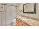 Bathroom with granite countertops, wood cabinets, and shower curtain at 2705 E Verbena Dr, Phoenix, AZ 85048