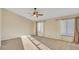 Bright bedroom with carpet, ceiling fan, and natural light from two windows at 2705 E Verbena Dr, Phoenix, AZ 85048
