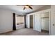 Bedroom with a ceiling fan and closets with both sliding and hinged doors at 2705 E Verbena Dr, Phoenix, AZ 85048