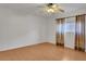 Bedroom with wood floors, ceiling fan and curtained window at 2705 E Verbena Dr, Phoenix, AZ 85048
