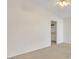 This carpeted bedroom includes a ceiling fan and an open walk-in closet at 2705 E Verbena Dr, Phoenix, AZ 85048