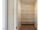 A bright walk-in closet with built-in shelving for organized storage solutions at 2705 E Verbena Dr, Phoenix, AZ 85048
