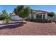 Charming front yard with mature trees and rock landscaping at 2705 E Verbena Dr, Phoenix, AZ 85048