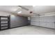 Spacious garage equipped with overhead lighting, storage cabinets and epoxy flooring at 2705 E Verbena Dr, Phoenix, AZ 85048