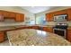 Spacious kitchen with granite counters, wood cabinets, and stainless steel appliances at 2705 E Verbena Dr, Phoenix, AZ 85048