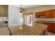 Open kitchen with large granite island, plenty of counter space, and natural light at 2705 E Verbena Dr, Phoenix, AZ 85048
