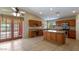 Modern kitchen with granite countertops, center island, tile floors and natural light at 2705 E Verbena Dr, Phoenix, AZ 85048
