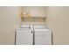 Laundry room featuring modern washer and dryer with overhead shelving at 2705 E Verbena Dr, Phoenix, AZ 85048