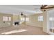 Large living room with fireplace, ceiling fans, and multiple windows for natural light at 2705 E Verbena Dr, Phoenix, AZ 85048