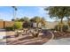 Outdoor space with stone benches and tables, lush landscaping, and privacy wall at 2705 E Verbena Dr, Phoenix, AZ 85048
