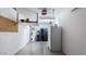 A utility room with a refrigerator, water heater, and shelving at 2705 E Verbena Dr, Phoenix, AZ 85048