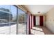 Sun-filled room with large windows, tiled floor, and access to outdoor space at 2705 E Verbena Dr, Phoenix, AZ 85048