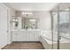 Modern bathroom with double vanity, soaking tub, and walk-in shower at 3045 E Bloomfield Pkwy, Gilbert, AZ 85296