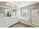 Elegant bathroom featuring a double vanity, soaking tub, and glass shower at 3045 E Bloomfield Pkwy, Gilbert, AZ 85296