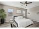 Bright bedroom with a queen bed, large windows, and neutral decor at 3045 E Bloomfield Pkwy, Gilbert, AZ 85296