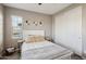 Cozy bedroom with a queen bed, neutral decor, and double doors to closet at 3045 E Bloomfield Pkwy, Gilbert, AZ 85296