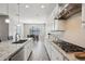 Modern kitchen boasts white cabinets, granite counters, and a gas cooktop at 3045 E Bloomfield Pkwy, Gilbert, AZ 85296