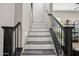 Modern staircase with black metal railing and gray-white risers at 3045 E Bloomfield Pkwy, Gilbert, AZ 85296