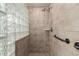 Bathroom featuring a walk-in shower with grab bars and glass block wall at 36601 N Mule Train Rd # B19, Carefree, AZ 85377