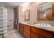 Elegant bathroom with double sinks, a large mirror, and a walk-in shower at 36601 N Mule Train Rd # B19, Carefree, AZ 85377