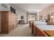 Guest bedroom with two twin beds, a writing desk, and patio access at 36601 N Mule Train Rd # B19, Carefree, AZ 85377