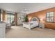 Main bedroom with plush bed, access to patio and ceiling fan at 36601 N Mule Train Rd # B19, Carefree, AZ 85377