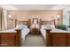 Guest bedroom with two twin beds and nightstands with lamps at 36601 N Mule Train Rd # B19, Carefree, AZ 85377