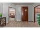 Inviting entryway with tile flooring and view into bedroom and laundry area at 36601 N Mule Train Rd # B19, Carefree, AZ 85377