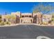 Front view of a two-story stucco home with a two-car garage and desert landscaping at 36601 N Mule Train Rd # B19, Carefree, AZ 85377