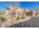 Side view of a two-story home showcasing desert landscaping and architectural details at 36601 N Mule Train Rd # B19, Carefree, AZ 85377