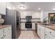 Well-equipped kitchen features stainless steel appliances and granite counters at 36601 N Mule Train Rd # B19, Carefree, AZ 85377