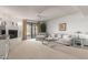 Living room with a fireplace, gray sectional sofa, and access to a patio at 36601 N Mule Train Rd # B19, Carefree, AZ 85377