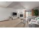 Living room with fireplace, light gray couch, and access to a patio at 36601 N Mule Train Rd # B19, Carefree, AZ 85377