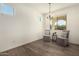 Bright dining room with hardwood floors and modern light fixture at 37692 N Bridlewood Ln, San Tan Valley, AZ 85140