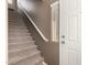 Carpeted staircase with neutral walls and a white railing at 42424 N Gavilan Peak Pkwy # 9206, Anthem, AZ 85086